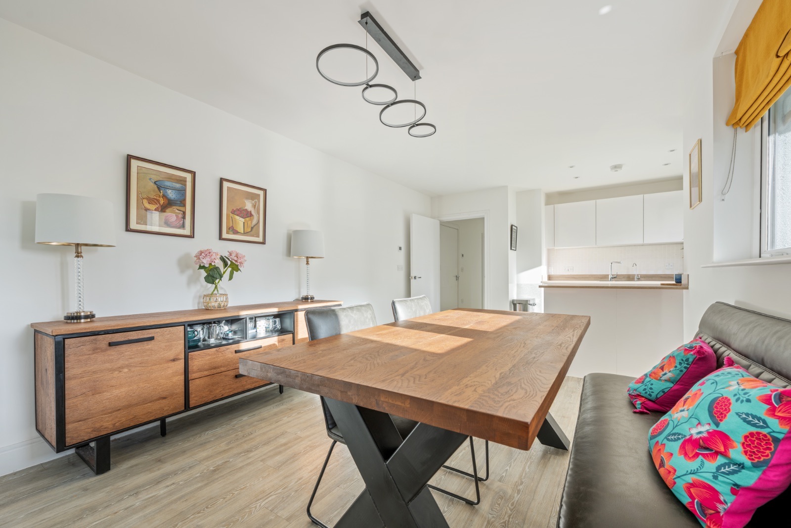 Dining area with solid oak table, designer pendant lighting and breakfast bar