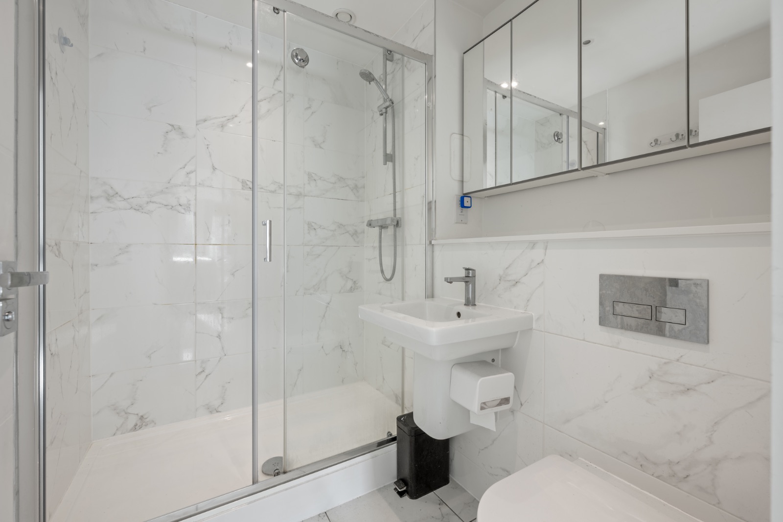 Master en-suite with marble-effect tiles and walk-in shower