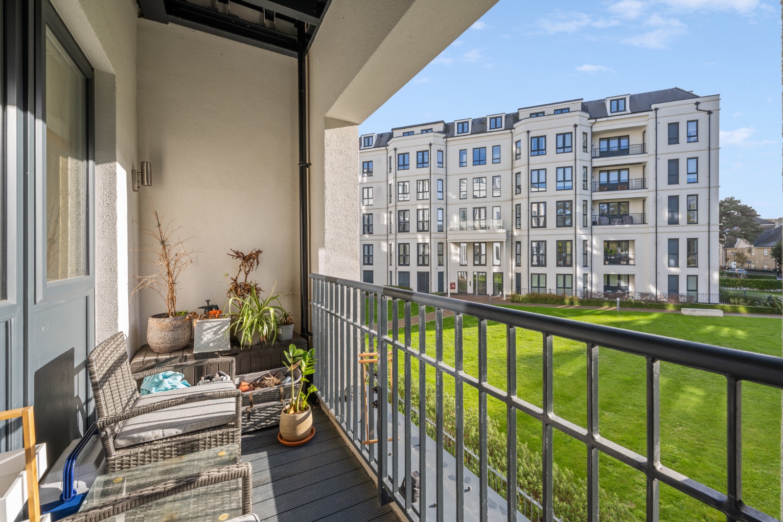 South-facing private balcony with seating and views over the lawn and gardens
