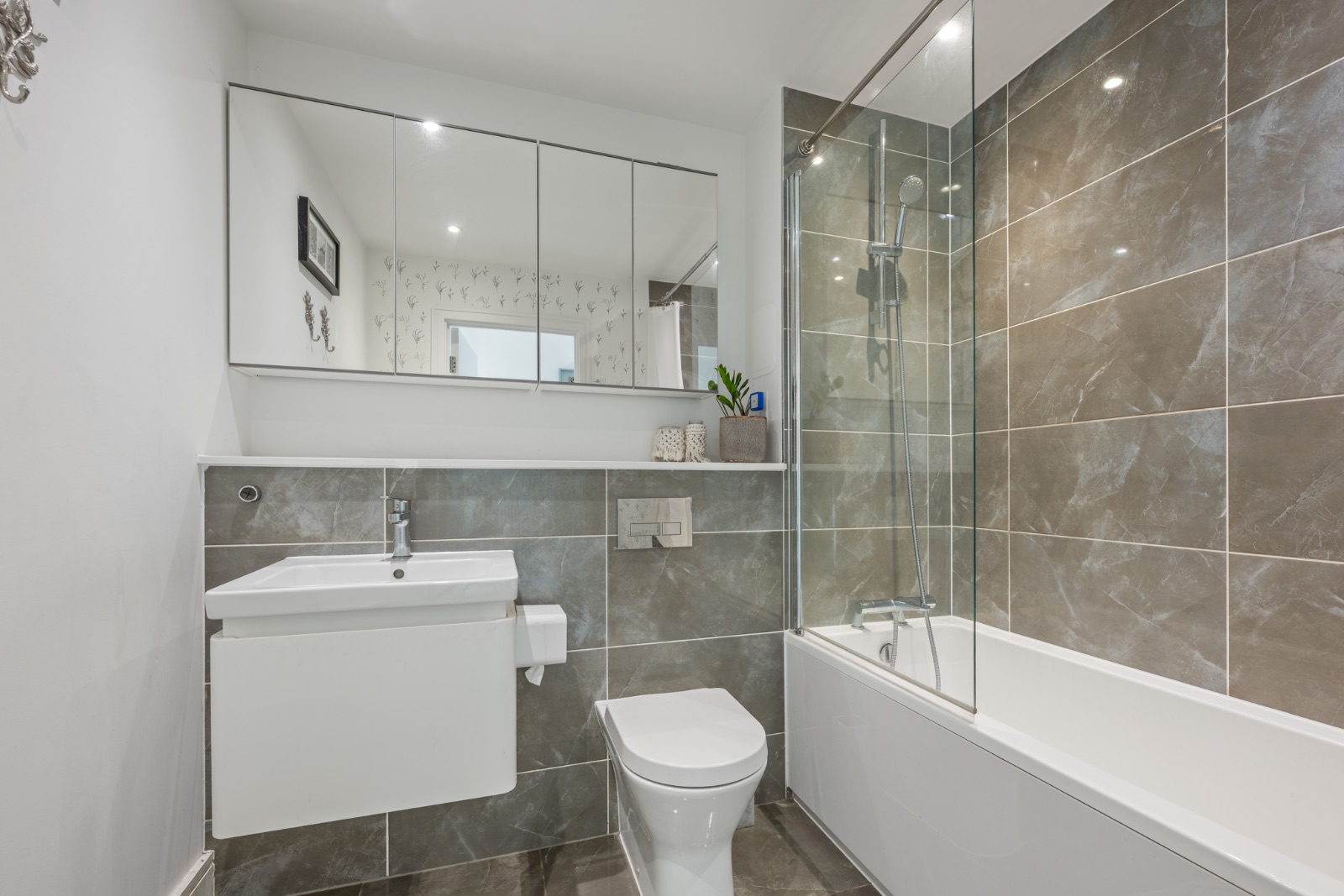Second bathroom with full bath, glass shower screen and grey marble tiles